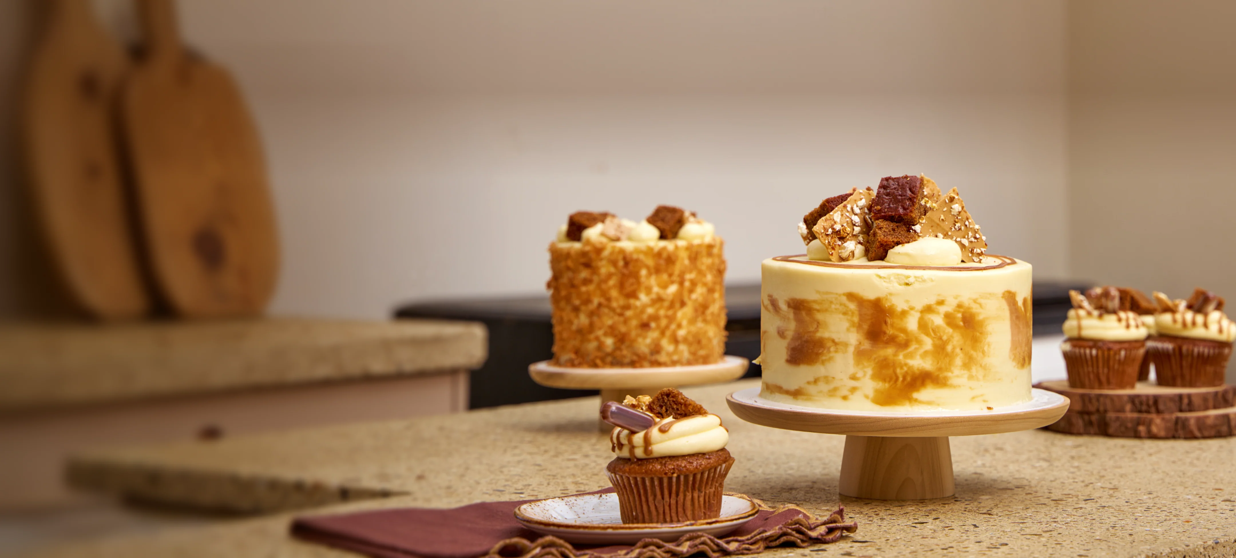 Artisan cupcakes and miniature desserts decorated with frosting and delicate edible toppings